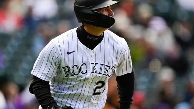Colorado Rockies' Mickey Moniak follows the flight of his two-run home run off Washington Nationals starting pitcher MacKenzie Gore in the second inning of a baseball game Saturday, April 19, 2025, in Denver. (Andy Cross/The Denver Post via AP)